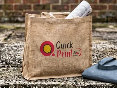 Screen-printed jute tote bag and non-woven bag on a concrete step, printed in Hyderabad