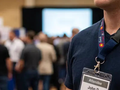 Printed navy lanyard with safety breakaway clip worn at a conference, Hyderabad