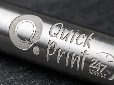 Close-up of a laser-engraved logo on a brushed metal promotional pen, Hyderabad