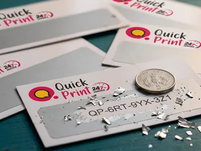 Scratch card being scratched with a coin revealing a unique code, printed in Hyderabad by QuickPrintt